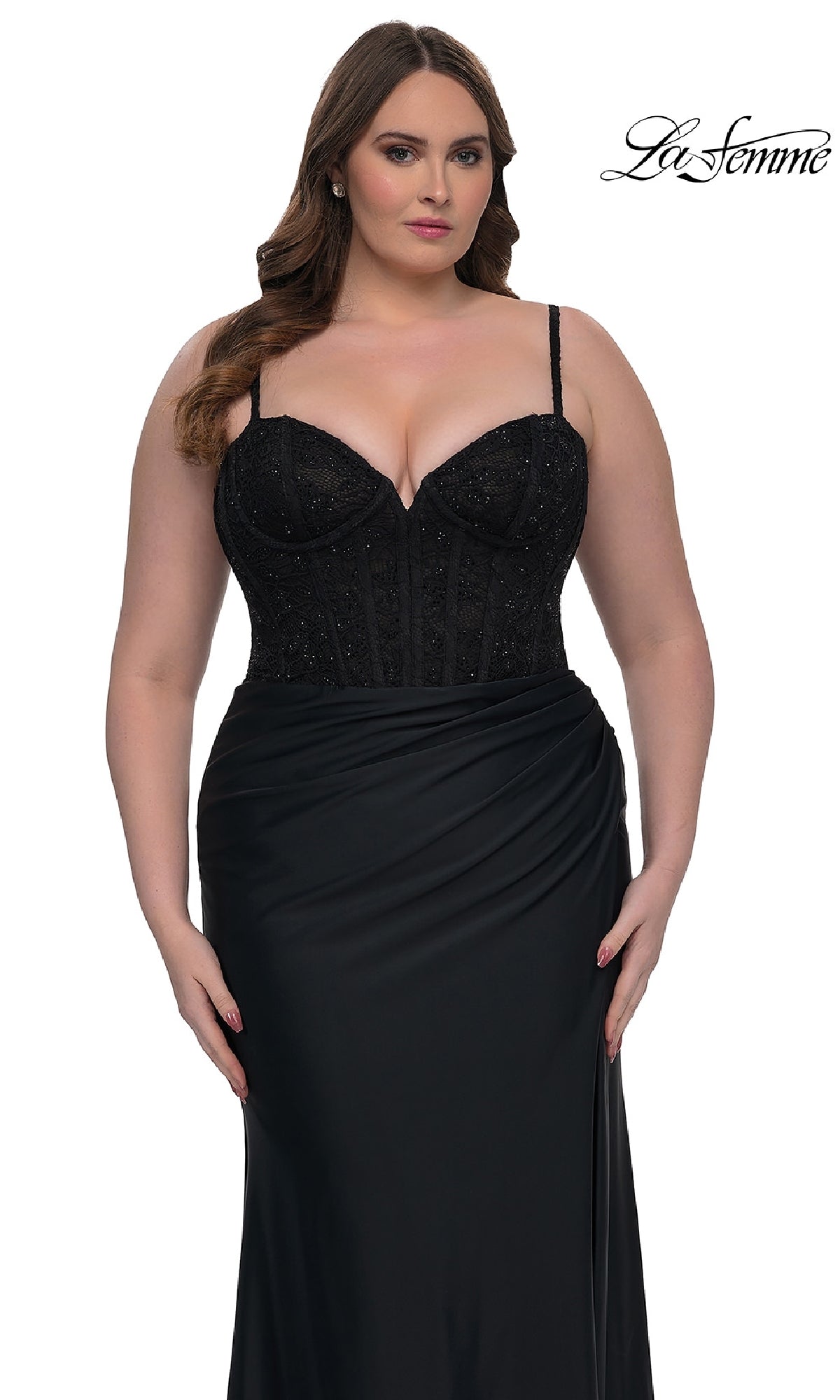 A woman models the Plus-Size Long Corset Prom Dress: La Femme 32449, a black sleeveless gown with a beaded bodice and draped skirt, against a white background. The